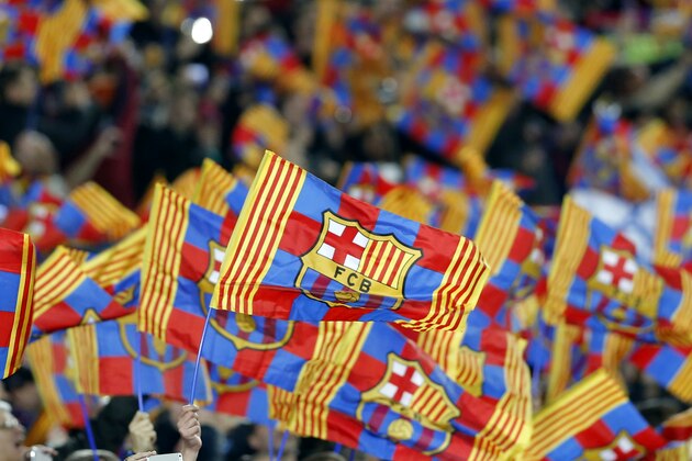 FC Barcelona fans wave flags ahead of a Champions League round of 16 second leg, soccer match between FC Barcelona and Manchester City at Camp Nou stadium, in Barcelona, Spain, Wednesday, March 18, 2015. (AP Photo/Emilio Morenatti)