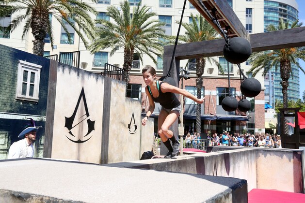 IMAGE DISTRIBUTED FOR UBISOFT - Kacy Catanzaro runs the parkour course at Ubisoft's Assassin's Creed Experience during Comic-Con on Thurs., July 24, 2014, in San Diego. The Assassin's Creed Experience is open to the public through Sun. July 27th.  (Photo by Casey Rodgers/Invision for Ubisoft/AP Images)