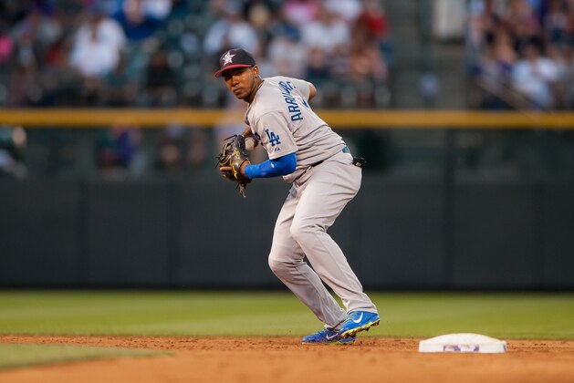 DENVER, CO - JULY 4:  Erisbel Arruebarrena #11 of the Los Angeles Dodgers sets to throw to first base for a putout against the Colorado Rockies at Coors Field on July 4, 2014 in Denver, Colorado. The Dodgers beat the Rockies 9-0. (Photo by Dustin Bradford/Getty Images)