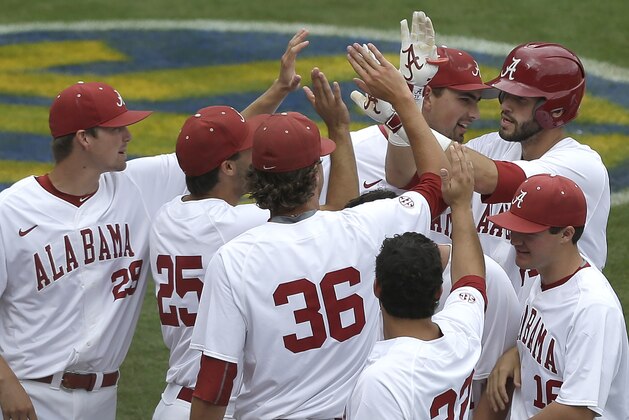 Alabama’s Will Haynie, rear right,  celebrates with teammates  after hitting a home run against Missouri during the seventh inning of a game at the Southeastern Conference college baseball tournament at the Hoover Met, Thursday, May 21, 2015, in Hoover, Ala. (AP Photo/Butch Dill)