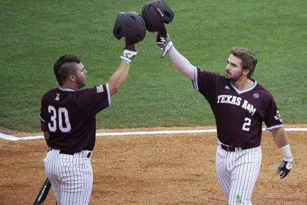 Texas A&M Mitchell Nau, left, celebrates with Ryne Birk, right after Birk hit a home run during the second inning of a Southeastern Conference college baseball tournament game against Vanderbilt at the Hoover Met, Thursday, May 21, 2015, in Hoover, Ala. (AP Photo/Brynn Anderson)
