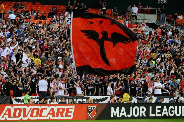 Apr 18, 2015; Washington, DC, USA; D.C. United fans wave flags against the Houston Dynamo during the first half at Robert F. Kennedy Memorial. Mandatory Credit: Brad Mills-USA TODAY Sports