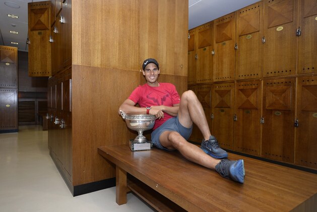PARIS, FRANCE - JUNE 08:  Rafael Nadal of Spain poses in the locker room with the Coupe des Mousquetaires trophy after the men's singles final against Novak Djokovic of Serbia in the French Open at Roland Garros on June 8, 2014 in Paris, France. (Photo by Christophe Saidi/FFT - Pool/Getty Images)