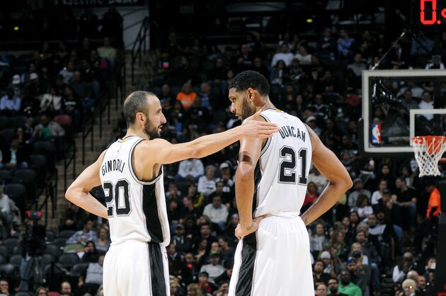 SAN ANTONIO, TX - NOVEMBER 5: Manu Ginobili #20 and Tim Duncan #21 of the San Antonio Spurs speak during a game against the Atlanta Hawks at the AT&T Center on November 5, 2014 in San Antonio, Texas. NOTE TO USER: User expressly acknowledges and agrees that, by downloading and or using this photograph, user is consenting to the terms and conditions of the Getty Images License Agreement. Mandatory Copyright Notice: Copyright 2014 NBAE (Photos by D. Clarke Evans/NBAE via Getty Images)