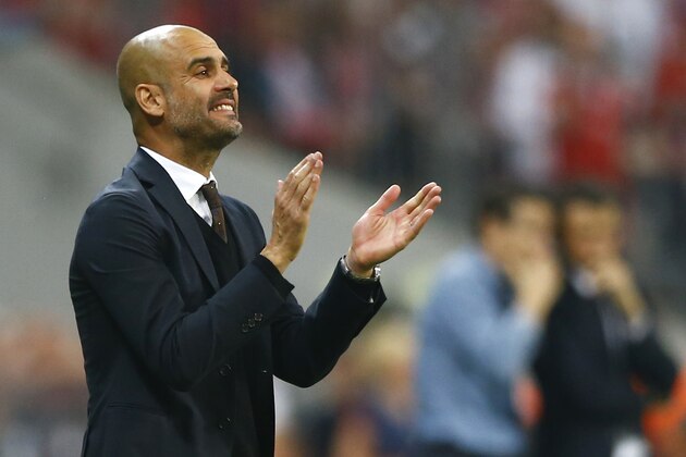 Bayern's head coach Pep Guardiola instructs his players during the soccer Champions League second leg semifinal match between Bayern Munich and FC Barcelona at Allianz Arena in Munich, southern Germany, Tuesday, May 12, 2015. (AP Photo/Matthias Schrader)