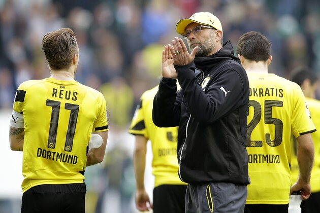 Dortmund's head coach Juergen Klopp applauds towards the supporters after the German first division Bundesliga soccer match between VfL Wolfsburg and Borussia Dortmund in Wolfsburg, Germany, Saturday, May 16, 2015. Wolfsburg defeated Dortmund by 2-1. (AP Photo/Michael Sohn)