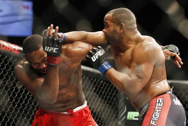 Daniel Cormier hits Jon Jones during their light heavyweight title mixed martial arts bout at UFC 182, Saturday, Jan. 3, 2015, in Las Vegas. (AP Photo/John Locher)
