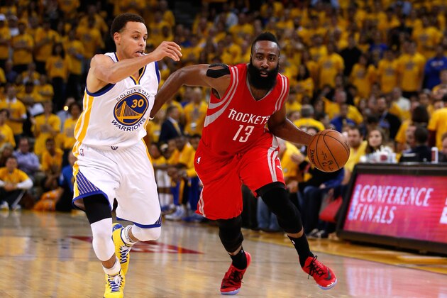 OAKLAND, CA - MAY 21:  James Harden #13 of the Houston Rockets handles the ball against Stephen Curry #30 of the Golden State Warriors in the second quarter during game two of the Western Conference Finals of the 2015 NBA PLayoffs at ORACLE Arena on May 21, 2015 in Oakland, California. NOTE TO USER: User expressly acknowledges and agrees that, by downloading and or using this photograph, user is consenting to the terms and conditions of Getty Images License Agreement.  (Photo by Ezra Shaw/Getty Images)