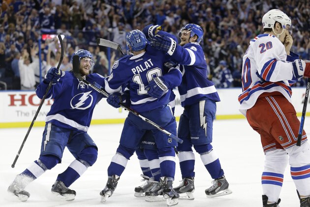 Teammates congratulate Tampa Bay Lightning center Tyler Johnson (9) after Johnson scored a goal in the second period of Game 3 of the Eastern Conference finals during an NHL hockey Stanley Cup playoffs Wednesday, May 20, 2015, in Tampa, Fla. To the right is New York Rangers left wing Chris Kreider (20). (AP Photo/Chris O'Meara)