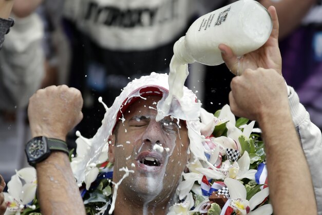 Tony Kanaan, of Brazil, celebrates by pouring the winners milk over his heads after winning the Indianapolis 500 auto race at the Indianapolis Motor Speedway in Indianapolis, Sunday, May 26, 2013. (AP Photo/Michael Conroy)