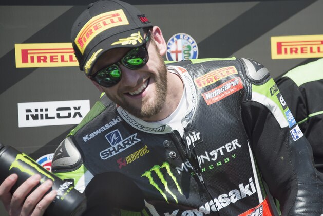 IMOLA, ITALY - MAY 10:  Tom Sykes of Great Britain and Kawasaki Racing Team celebrates the second place under the podium at the end of the WSBK race 2 during the World Superbikes - Race at Enzo & Dino Ferrari Circuit on May 10, 2015 in Imola, Italy.  (Photo by Mirco Lazzari gp/Getty Images)