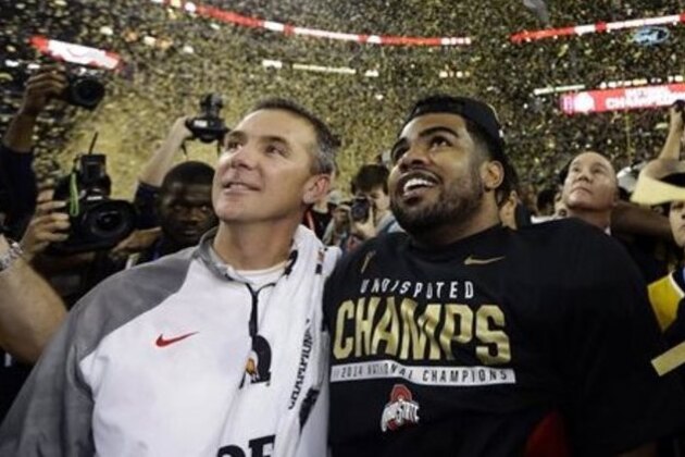 CORRECTS PLAYER AT RIGHT  TO EZEKIEL ELLIOTT- Ohio State head coach Urban Meyer and Ezekiel Elliott celebrate after the NCAA college football playoff championship game against Oregon Monday, Jan. 12, 2015, in Arlington, Texas. Ohio State won 42-20. (AP Photo/David J. Phillip)