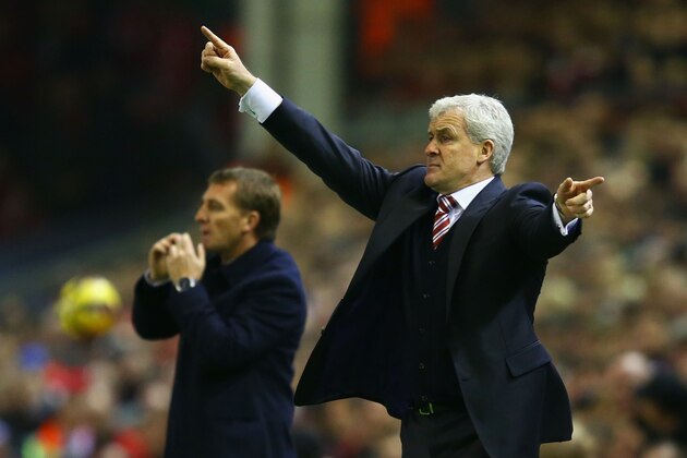 LIVERPOOL, ENGLAND - NOVEMBER 29:  Mark Hughes manager of Stoke City and Brendan Rodgers manager of Liverpool (L) give instructions during the Barclays Premier League match between Liverpool and Stoke City at Anfield on November 29, 2014 in Liverpool, England.  (Photo by Richard Heathcote/Getty Images)
