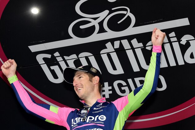 Italy's Sacha Modolo celebrates on the podium after winning the 13th stage of the Giro d'Italia, Tour of Italy cycling race from Montecchio Maggiore to the seaside resort of Jesolo, near Venice, Italy, Friday, May 22, 2015. Alberto Contador lost the overall lead of the Giro d'Italia to Fabio Aru after he was involved in a crash toward the end of Friday's 13th stage, which was won by Sacha Modolo. (Daniel Dal Zennaro/ANSA via AP)