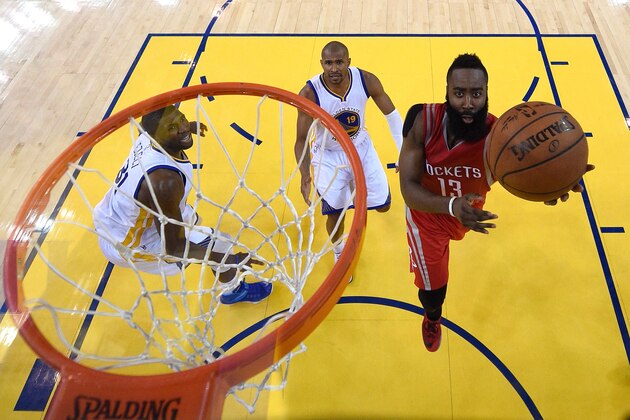 OAKLAND, CA - MAY 21: James Harden #13 of the Houston Rockets shoots against Festus Ezeli #31 and Leandro Barbosa #19 of the Golden State Warriors in the second half during game two of the Western Conference Finals of the 2015 NBA PLayoffs at ORACLE Arena on May 21, 2015 in Oakland, California. NOTE TO USER: User expressly acknowledges and agrees that, by downloading and or using this photograph, user is consenting to the terms and conditions of Getty Images License Agreement.  (Photo by John Mabanglo - Pool/Getty Images)