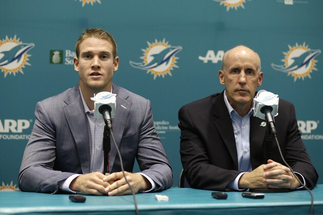 Miami Dolphins quarterback Ryan Tannehill responds to a question during a news conference, Tuesday, May 19, 2015, in Davie, Fla.Tannehill signed a $77.7 million, 4-year extension that keeps him under contract  with the Dolphins through 2020. At right is coach Joe Philbin. (AP Photo/Lynne Sladky)