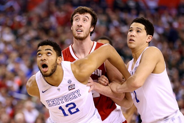 INDIANAPOLIS, IN - APRIL 04:  Karl-Anthony Towns #12 and Devin Booker #1 of the Kentucky Wildcats battle for position on a free throw with Frank Kaminsky #44 of the Wisconsin Badgers in the first half during the NCAA Men's Final Four Semifinal at Lucas Oil Stadium on April 4, 2015 in Indianapolis, Indiana.  (Photo by Andy Lyons/Getty Images)
