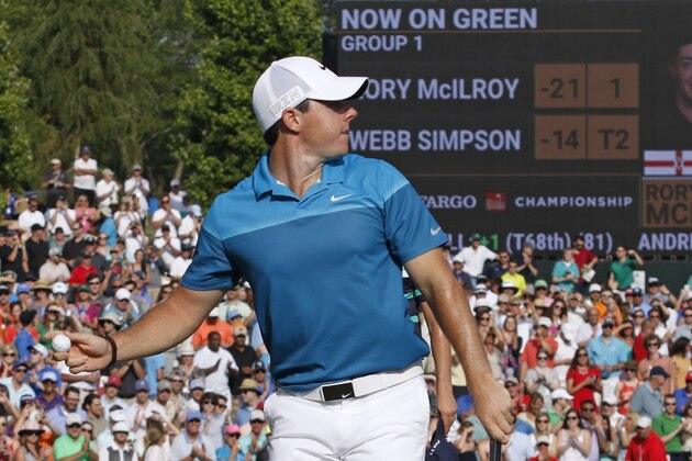 Rory McIlroy, of Northern Ireland, prepares to throw his ball into the crowd as he celebrates after winning the Wells Fargo Championship golf tournament at Quail Hollow Club in Charlotte, N.C., Sunday, May 17, 2015. (AP Photo/Bob Leverone)
