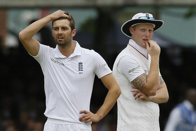 England's bowler Mark Wood, left, reacts as his teammate Ben Stokes looks on as a review shows that he had bowled a no ball to New Zealand's Martin Guptill, who had been caught at slip, but was give not out due to the no ball, during play on the second day of the first Test match at Lord's cricket ground in London, Friday, May 22, 2015. at right is England's Ben Stokes.(AP Photo/Kirsty Wigglesworth)
