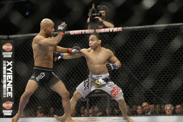 John Dodson, right, fights Demetrious Johnson during the UFC World Flyweight Championship on FOX 6 at the United Center in Chicago, Saturday, Jan. 26, 2013. Johnson won the bout by an unanimous decision. (AP Photo/Nam Y. Huh)