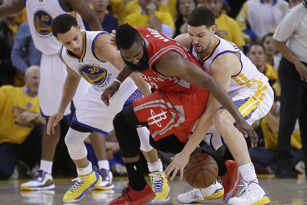 Houston Rockets guard James Harden, center, loses the ball on the game's final play as he Golden State Warriors guards Stephen Curry, left, and Klay Thompson defend during the second half of Game 2 of the NBA basketball Western Conference finals in Oakland, Calif., Thursday, May 21, 2015. The Warriors won 99-98. (AP Photo/Rick Bowmer)