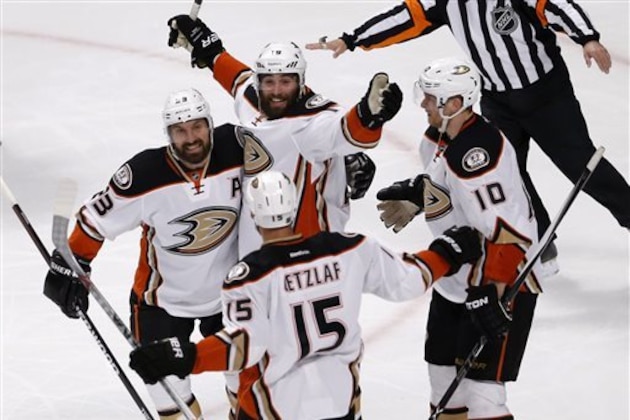 Anaheim Ducks celebrate the team's first score against the Chicago Blackhawks during the first period in Game 3 of the Western Conference finals of the NHL hockey Stanley Cup playoffs, Thursday, May 21, 2015, in Chicago. Clockwise from left are Francois Beauchemin, Patrick Maroon, Corey Perry and Ryan Getzlaf (15). (AP Photo/Charles Rex Arbogast)