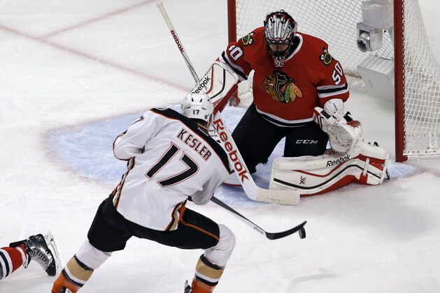 Anaheim Ducks center Ryan Kesler (17) shoots, but Chicago Blackhawks goalie Corey Crawford (50) stops the shot during the first period in Game 3 of the Western Conference finals in the NHL hockey Stanley Cup playoffs, Thursday, May 21, 2015, in Chicago. (AP Photo/Charles Rex Arbogast)