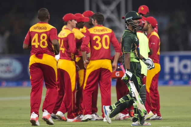 Zimbabwe's players celebrate the dismissal of Pakistan's Mukhtar Ahmed at the Gaddafi stadium in Lahore, Pakistan, Friday, May 22, 2015. With security measures so far holding up, international cricket returns to Pakistan on Friday for the first time in six years when it hosts Zimbabwe in a Twenty20 match. Pakistan beat Zimbabwe. (AP Photo/B.K. Bangash)