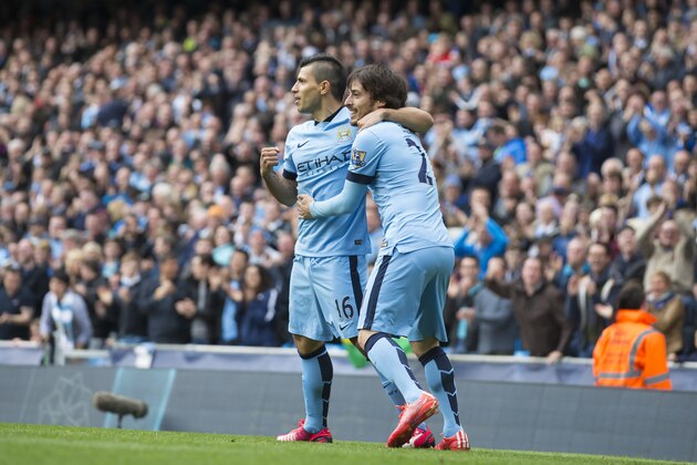 Manchester City's Sergio Aguero, left, celebrates with teammate David Silva after scoring past Queens Park Rangers' goalkeeper Robert Green during the English Premier League soccer match between Manchester City and Queens Park Rangers at the Etihad Stadium, Manchester, England, Sunday May 10, 2015. (AP Photo/Jon Super)