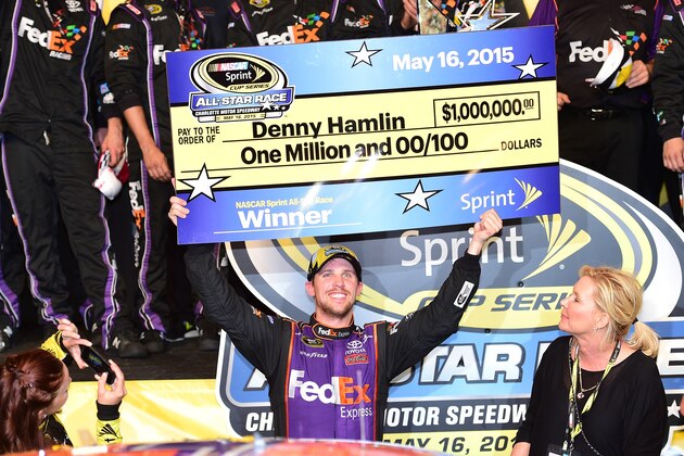 CHARLOTTE, NC - MAY 16:  Denny Hamlin, driver of the #11 FedEx Express Toyota, celebrates in victory lane after winning the NASCAR Sprint Cup Series Sprint All-Star Race at Charlotte Motor Speedway on May 16, 2015 in Charlotte, North Carolina.  (Photo by Jared C. Tilton/Getty Images)