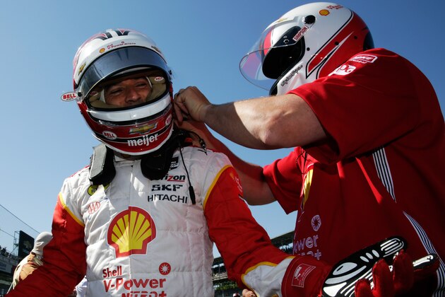 INDIANAPOLIS, IN - MAY 22:  Helio Castroneves of Brazil, driver of the #3 Team Penske Chevrolet, prepares to enter his car for final practice on Carb Day for the 99th running of the Indianapolis 500 mile race at Indianapolis Motorspeedway on May 22, 2015 in Indianapolis, Indiana.  Team owner Roger Penske looks on from behind.  (Photo by Jamie Squire/Getty Images)