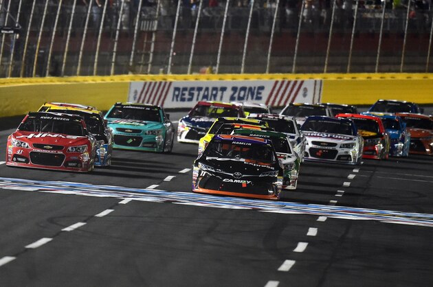 CHARLOTTE, NC - MAY 16: Denny Hamlin, driver of the #11 FedEx Express Toyota, leads the field in a restart during the NASCAR Sprint Cup Series Sprint All-Star Race at Charlotte Motor Speedway on May 16, 2015 in Charlotte, North Carolina.  (Photo by Drew Hallowell/Getty Images)