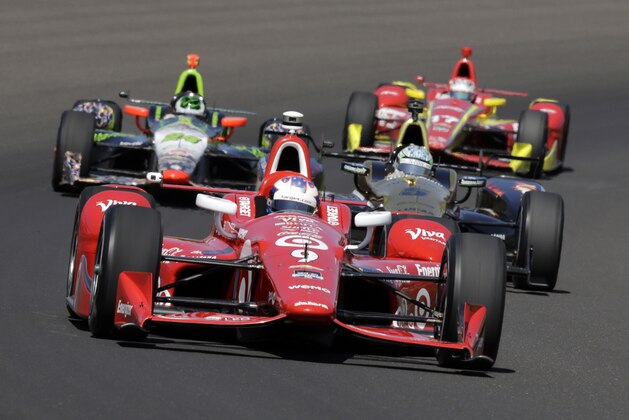Scott Dixon, of New Zealand, drives through the first turn during the final practice session for the Indianapolis 500 auto race at Indianapolis Motor Speedway in Indianapolis, Friday, May 22, 2015.  (AP Photo/R Brent Smith)