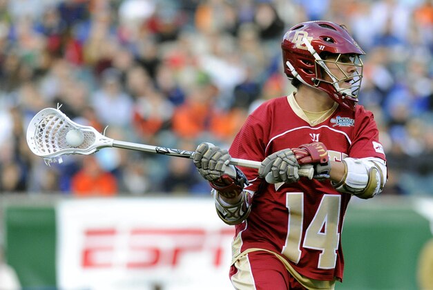 May 25, 2013; Philadelphia, PA, USA; Denver Pioneers midfielder Wesley Berg (14) looks to pass against the Syracuse Orange during the first quarter of the 2013 NCAA Division I men's lacrosse semifinals at Lincoln Financial Field.  Mandatory Credit: Rich Barnes-USA TODAY Sports