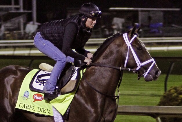 Exercise rider Patti Krotenko gallops Kentucky Derby entrant Carpe Diem at Churchill Downs in Louisville, Ky., Friday, May 1, 2015.  (AP Photo/Garry Jones)