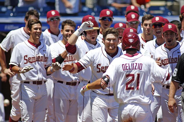 Florida State's Ben DeLuzio (21) is congratulated by teammates after hitting a solo home run against Louisville during the the bottom of the eighth inning of an NCAA college ACC tournament baseball game Saturday, May 23, 2015, in Durham, N.C. Florida State won 6-0 to advance to the finals Sunday. (AP Photo/Karl B DeBlaker)