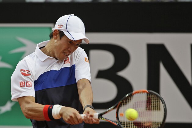 Kei Nishikori , of Japan, returns the ball to Novak Djokovic, of Serbia,  during a quarter final match at the Italian Open tennis tournament, in Rome, Friday, May 15, 2015. Djokovic beat Nishikori  6-3, 3-6, 6-1.  (AP Photo/Alessandra Tarantino)