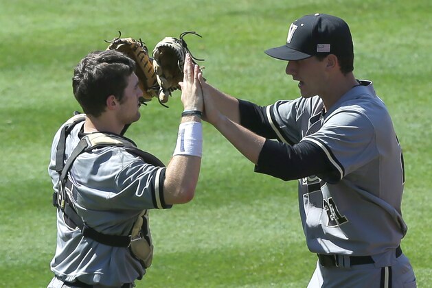 Vanderbilt’s Jason Delay, left, and John Kilichowski (21) celebrate after the last out to defeat Texas A&M in a game at the Southeastern Conference college baseball tournament Saturday, May 23, 2015, in Hoover, Ala. (AP Photo/Butch Dill)