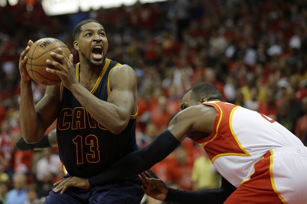 Cleveland Cavaliers center Tristan Thompson (13) moves past Atlanta Hawks forward Paul Millsap (4) during the second half in Game 2 of the Eastern Conference finals of the NBA basketball playoffs, Friday, May 22, 2015, in Atlanta. (AP Photo/David Goldman)