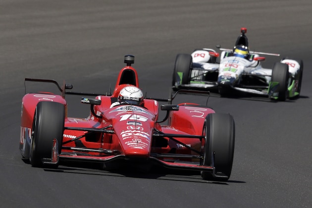 Graham Rahal leads Sebastien Bourdais, of France, through the first turn during the final practice session for the Indianapolis 500 auto race at Indianapolis Motor Speedway in Indianapolis, Friday, May 22, 2015.  (AP Photo/R Brent Smith)