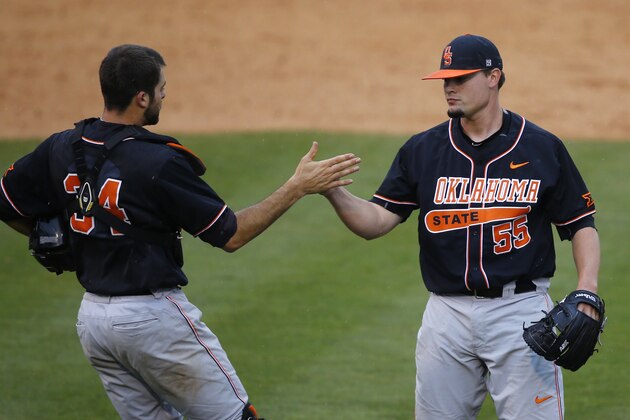 Oklahoma State relief pitcher Michael Higgins (55) is congratulated by catcher Bryan Case (34) after Oklahoma State defeated Oklahoma 5-1 in an NCAA semifinal college baseball game during the Big 12 conference tournament Saturday, May 23, 2015, in Tulsa, Okla. (AP Photo/Sue Ogrocki)