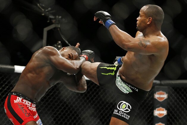 Daniel Cormier kicks Anthony Johnson during their light heavyweight title mixed martial arts bout at UFC 187 on Saturday, May 23, 2015, in Las Vegas. (AP Photo/John Locher)