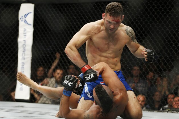 Chris Weidman pounds Vitor Belfort during their middleweight mixed martial arts bout at UFC 187 Saturday, May 23, 2015, in Las Vegas. (AP Photo/John Locher)