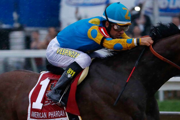 May 16, 2015; Baltimore, MD, USA; Victor Espinoza aboard American Pharoah leads the pack out of turn four during the 140th Preakness Stakes at Pimlico Race Course. Mandatory Credit: Geoff Burke-USA TODAY Sports