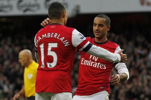 Arsenal's Theo Walcott, right, celebrates his goal against Tottenham Hotspur with teammate Alex Oxlade-Chamberlain during their English Premier League soccer match at Emirates stadium, London, Saturday, Nov. 17, 2012. (AP Photo/Sang Tan)