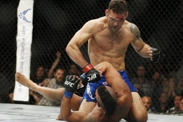 Chris Weidman pounds Vitor Belfort during their middleweight mixed martial arts bout at UFC 187 Saturday, May 23, 2015, in Las Vegas. (AP Photo/John Locher)