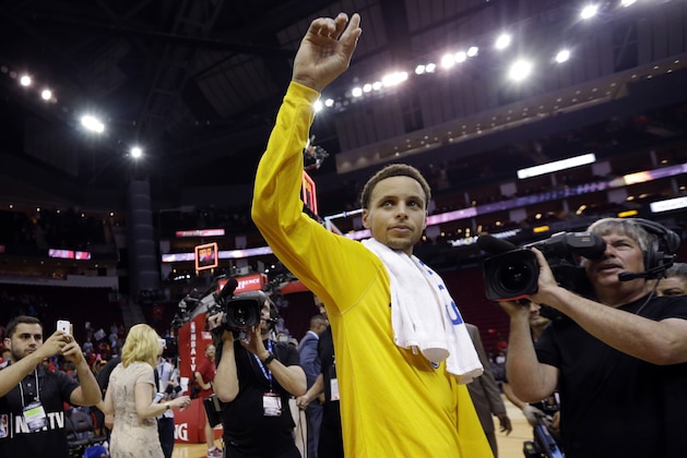 Golden State Warriors guard Stephen Curry gestures after Game 3 of the NBA basketball Western Conference finals against the Houston Rockets on Saturday, May 23, 2015, in Houston. The Warriors won 115-80. (AP Photo/David J. Phillip)