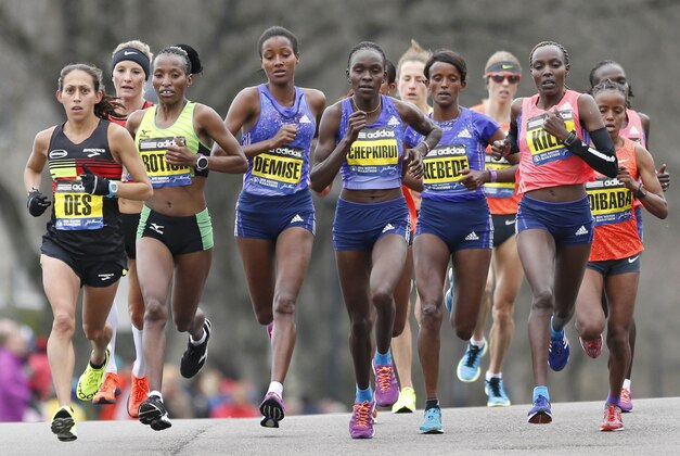 Apr 20, 2015; Boston, MA, USA; Desiree Davila Linden  (USA) leads Caroline Rotich  (KEN) and the pack during the 2015 Boston Marathon. Mandatory Credit: Greg M. Cooper-USA TODAY Sports