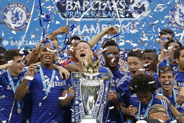 Chelsea's John Terry holds the trophy after the English Premier League soccer match between Chelsea and Sunderland at Stamford Bridge stadium in London, Sunday May 24, 2015. Chelsea were awarded the trophy after winning the English Premier League.  (AP Photo/Matt Dunham)