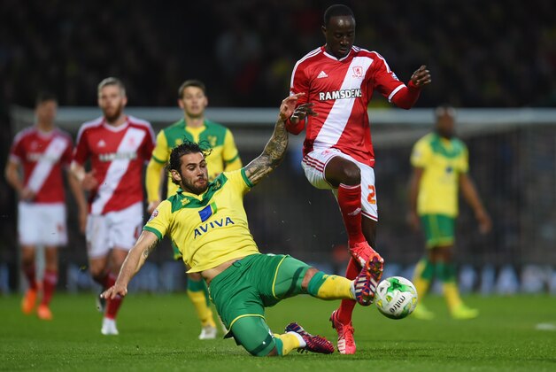 NORWICH, ENGLAND - APRIL 17:  Albert Adomah of Middlesbrough is tackled by Bradley Johnson of Norwich City during the Sky Bet Championship match between Norwich City and Middlesbrough at Carrow Road on April 17, 2015 in Norwich, England.  (Photo by Tom Dulat/Getty Images)